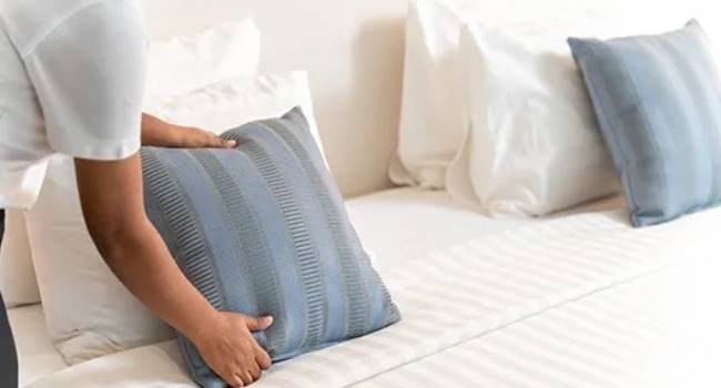 Residential bedroom cleaning and bed preparation