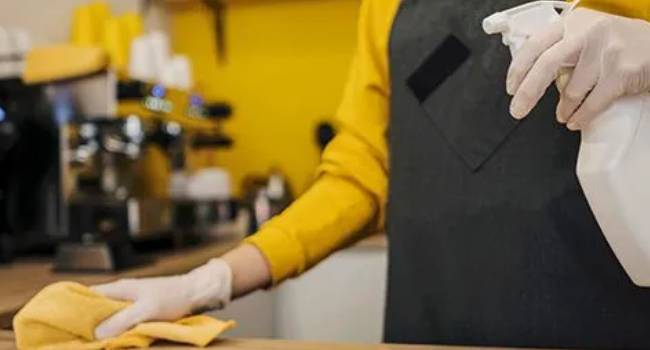 Professional cleaner wiping a breakroom counter