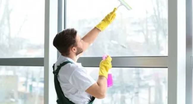 Professional cleaner washing business windows