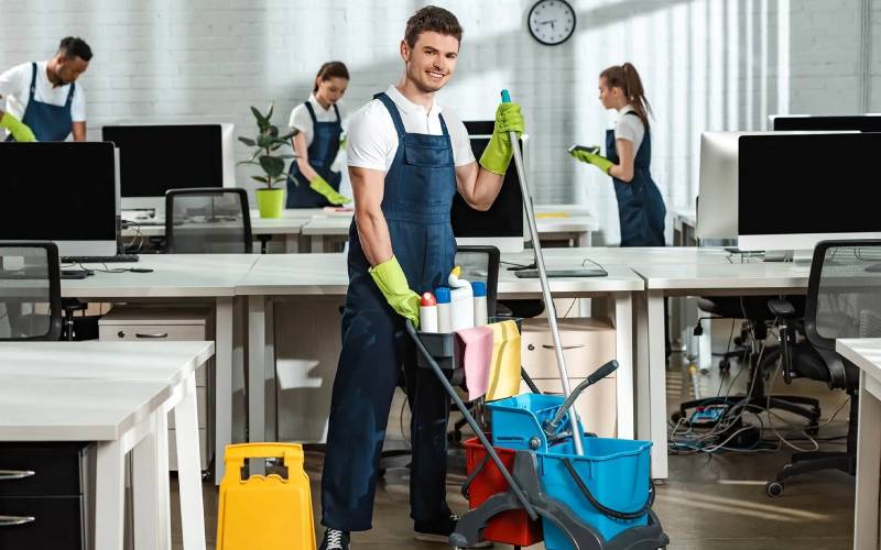 Professional office cleaning team deep cleaning a workspace