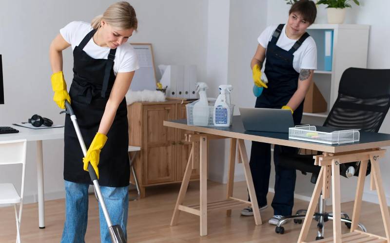 Professional cleaners maintaining a healthy office workspace