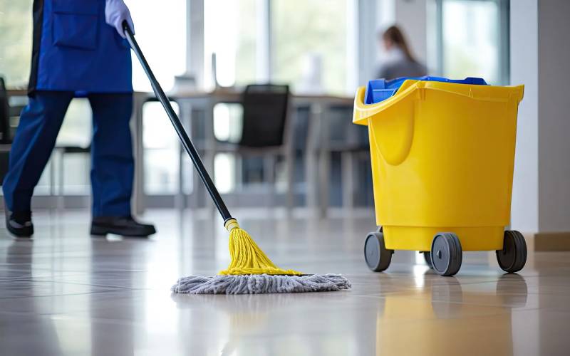 Professional cleaner mopping a clean commercial floor