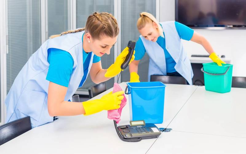 Professional commercial cleaners cleaning a conference room in Norwalk