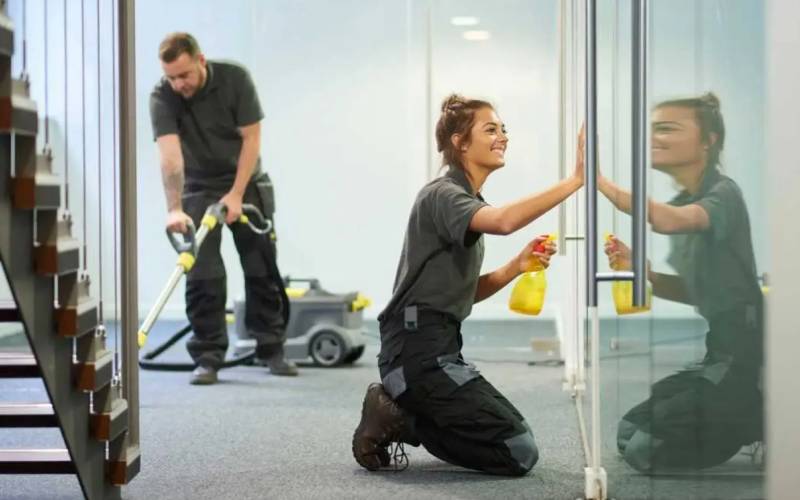 Commercial cleaners maintaining business glass and floors