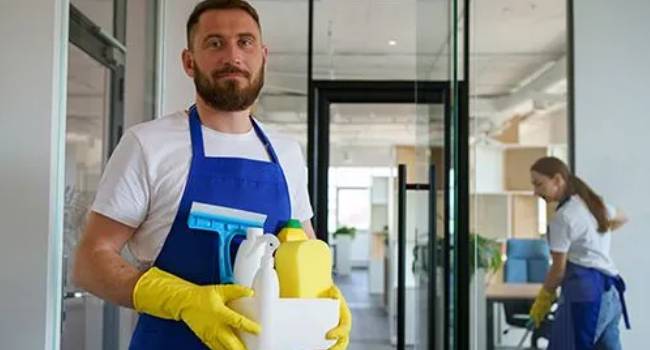 Professional cleaners carrying supplies for commercial deep cleaning