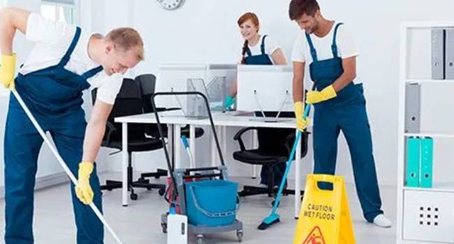 Professional cleaners mopping and cleaning an office workspace