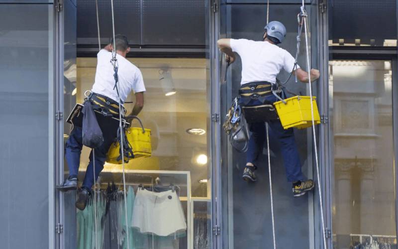 Professional window cleaning team cleaning commercial building windows