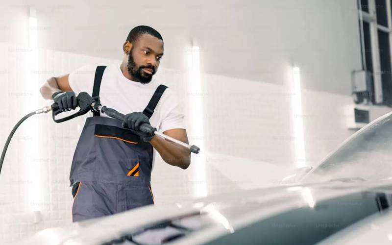 Professional cleaning and maintenance in a car dealership service area