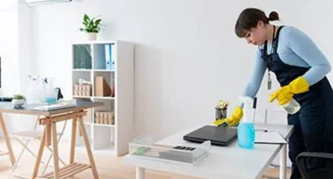 Professional cleaner using eco-friendly cleaning products in an office