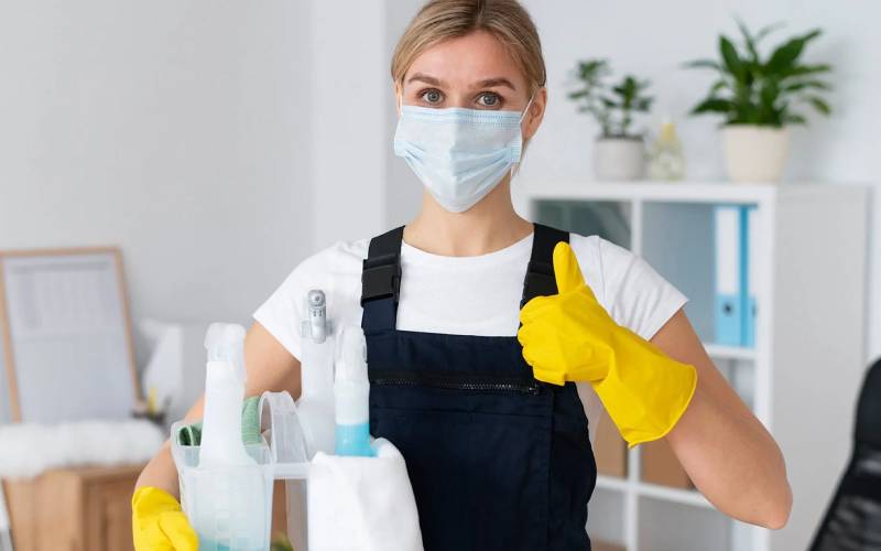 Professional cleaner using eco-friendly commercial cleaning products