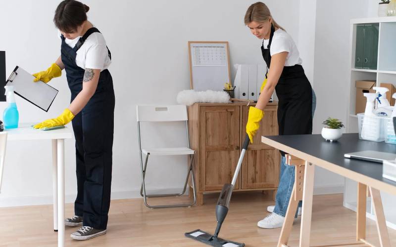 Professional cleaners maintaining a clean home office