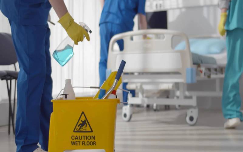 Professional cleaner disinfecting a hospital room