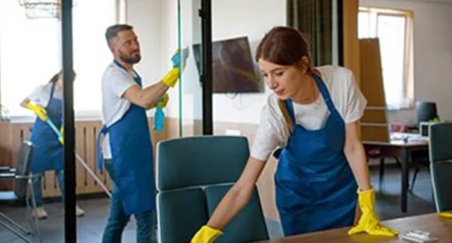 Professional cleaners maintaining a clean meeting room